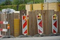 Civil engineering construction site, the shaft secured with metal plates and marked with two aiming tables and warning lights to s