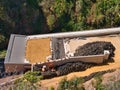 Civil engineering project showing rock shed construction using large quantities of vehicle tyres to form a cushion layer Royalty Free Stock Photo