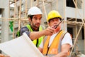 Civil engineers team with safety hard hat working together at construction site outdoor, Construction workers checking Royalty Free Stock Photo