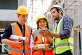 Civil engineers team with safety hard hat working together at construction site outdoor, Construction workers checking Royalty Free Stock Photo
