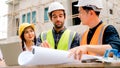 Civil engineers team with safety hard hat working together at construction site outdoor, Construction workers checking Royalty Free Stock Photo