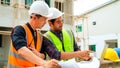 Civil engineers team with safety hard hat working together at construction site outdoor, Construction workers checking Royalty Free Stock Photo