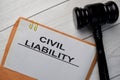 Civil Liability text with document brown envelope and gavel isolated on office desk