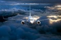 Civil passenger plane flying on a high altitude above the storm clouds during sunset Royalty Free Stock Photo