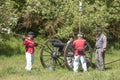 Civil war artillery reenactors load canon.