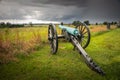 A civil war cannon points across the battlefield at Cemetery Ridge as storm clouds gather Royalty Free Stock Photo