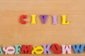 CIVIL word on wooden background composed from colorful abc alphabet block wooden letters, copy space for ad text. Learning english Royalty Free Stock Photo