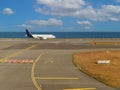 Civilian airplane on the runway at airport near the sea