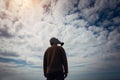 Civilian man wearing military gas mask. Human silhouette in a gas mask against moody sky. Atmospheric pollution, environmental