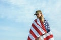 Civilian woman in her husband`s military cap. A widow with a flag of the united states left without her husband. Memorial Day to