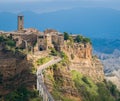 The famous Civita di Bagnoregio hit by the sun on a stormy day. Province of Viterbo, Lazio, Italy.