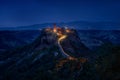 Civita di Bagnoregio, village in Tuscany landscape, Pienza in Italy. Spring day in nature. Bagnoregio night image with lights.