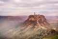 Civita di Bagnoregio, Lazio, Italy: picturesque landscape at dawn of the ancient village shrouded in fog on the steep tuff hill Royalty Free Stock Photo