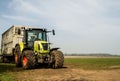 Green claas tractor and cattle sheep trailer