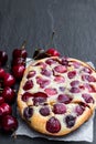 Clafouti cherry pie on black stone background Royalty Free Stock Photo