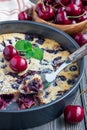 Clafoutis with cherry in baking dish, vertical Royalty Free Stock Photo