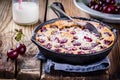 Clafoutis cherry pie on wooden background Royalty Free Stock Photo