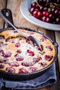 Clafoutis cherry pie on wooden background Royalty Free Stock Photo