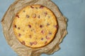 Clafoutis with strawberries on a blue background.