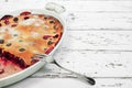 Clafoutis - traditional french cherry pie in a white baking dish Royalty Free Stock Photo