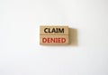 Claim denied symbol. Wooden blocks with words Claim denied. Beautiful white background. Business and Claim denied concept. Copy Royalty Free Stock Photo