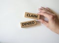Claim denied symbol. Wooden blocks with words Claim denied. Businessman hand. Beautiful white background. Business and Claim Royalty Free Stock Photo