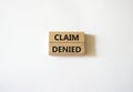 Claim denied symbol. Wooden blocks with words Claim denied. Beautiful white background. Business and Claim denied concept. Copy Royalty Free Stock Photo