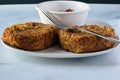 Clam cakes on a plate with sauce Royalty Free Stock Photo