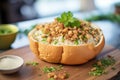 clam chowder in a bread bowl, topped with parsley and oyster crackers Royalty Free Stock Photo