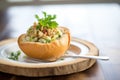 clam chowder in a bread bowl, topped with parsley and oyster crackers Royalty Free Stock Photo