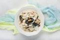 Clam chowder in a white plate. The main ingredients are shellfish, broth, butter, potatoes and onions