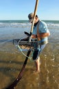 Shellfish gatherer coquinero on the beaches of Huelva, Andalusia region, Spain
