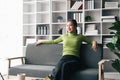 Clam millennial asian girl sit rest on sofa in living room. Happy young woman relax on comfortable couch furniture at Royalty Free Stock Photo