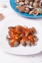 with shell on a blue plate on a white wood background with chilli and tomato sauce