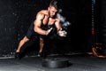 Young muscular man with big sweaty muscles doing push ups workout training with clap his hand above the barbell weight plate on th Royalty Free Stock Photo