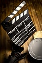 Clapper board with movie light and film reels Royalty Free Stock Photo