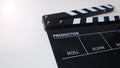 Clapper board or movie slate use in video production and cinema industry. It`s black color on white background with flare light Royalty Free Stock Photo