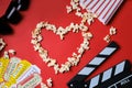 Clapper board, movies tickets and popcorn top view