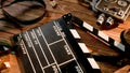 Clapper board, vintage video camera, movie film and3d glasses with popcorn kernels on wooden table. Cinematography Royalty Free Stock Photo