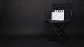 Clapperboard or clap board or movie slate with black director chair use in video production ,film, cinema industry on black Royalty Free Stock Photo