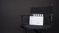 Clapperboard or clap board or movie slate with black director chair use in video production ,film, cinema industry on black Royalty Free Stock Photo