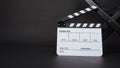 Clapperboard or clap board or movie slate with black director chair use in video production ,film, cinema industry on black Royalty Free Stock Photo