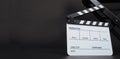 Clapperboard or clap board or movie slate with director chair use in video production ,film, cinema industry on black background Royalty Free Stock Photo