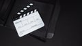 Clapperboard or clap board or movie slate with director chair use in video production ,film, cinema industry on black background Royalty Free Stock Photo