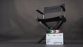 Clapperboard or clap board or movie slate with director chair use in video production ,film, cinema industry on black background Royalty Free Stock Photo