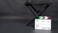 Director chair and Clapperboard or movie slate use in video production ,film, cinema industry on black background. Royalty Free Stock Photo