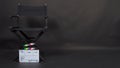 Clapperboard or clap board or movie slate with director chair use in video production ,film, cinema industry on black background Royalty Free Stock Photo