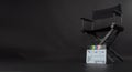 Clapperboard or clap board or movie slate with director chair use in video production ,film, cinema industry on black background Royalty Free Stock Photo