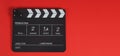 Clapperboard or clap board or movie slate .It is use in video production ,film, cinema industry on red background Royalty Free Stock Photo