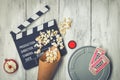 Clapperboard, movie reel and popcorn Royalty Free Stock Photo